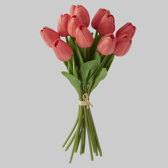 A bundle of coral-colored artificial tulips tied together.