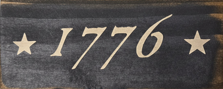 Wooden sign with '1776' and stars on a white background