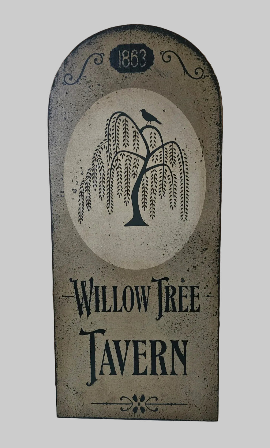 Decorative sign for Willow Tree Tavern with tree and bird design on a wooden background