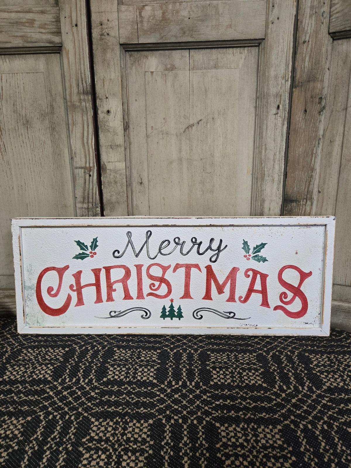 Christmas sign with 'Merry Christmas' text on a wooden background