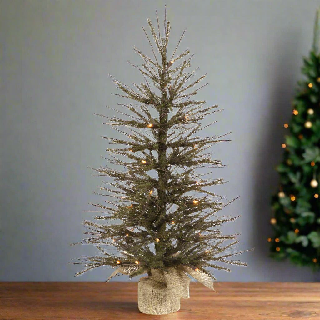 A 24-inch Vienna twig tree with realistic twigs, standing on a wooden block, unlit.