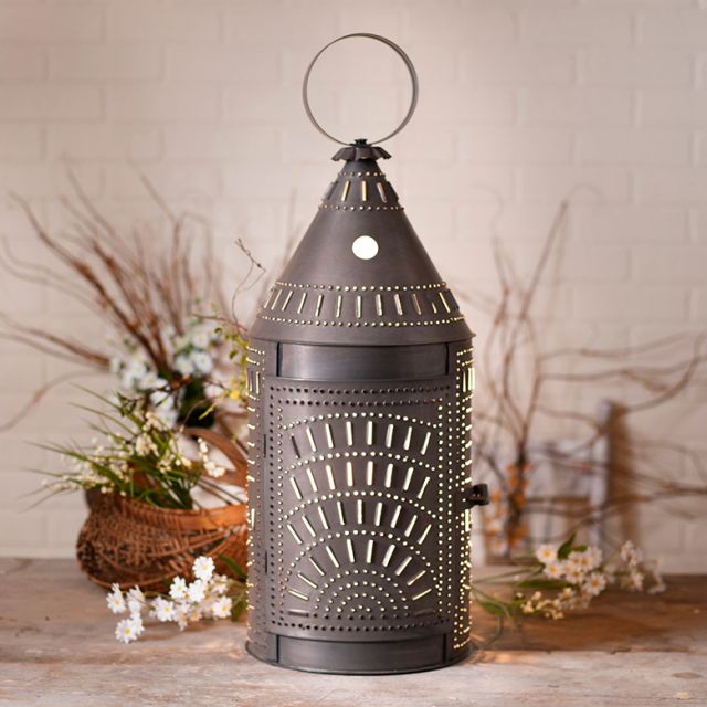 Decorative metal lantern on a wooden surface with a neutral background