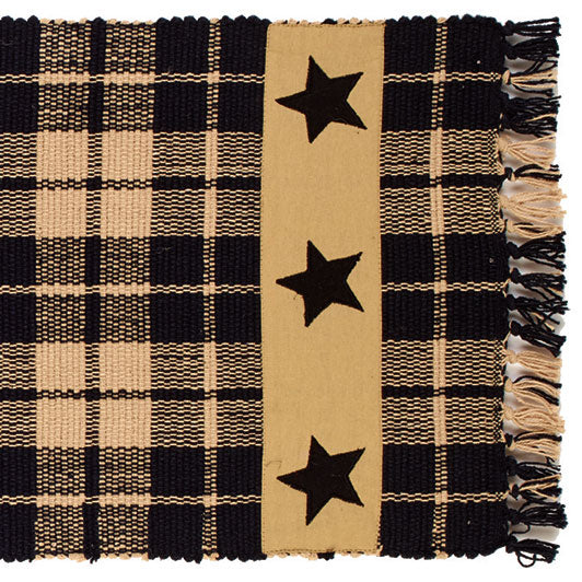 A 36-inch black farmhouse style runner rug with a star pattern, fringed on the sides.