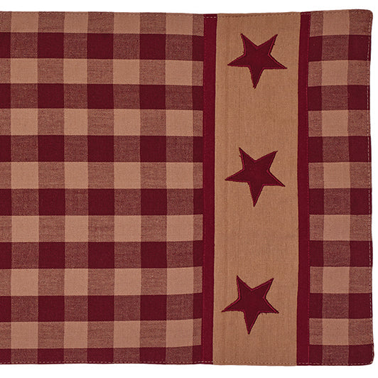 A red and beige checkered table runner with star appliques.