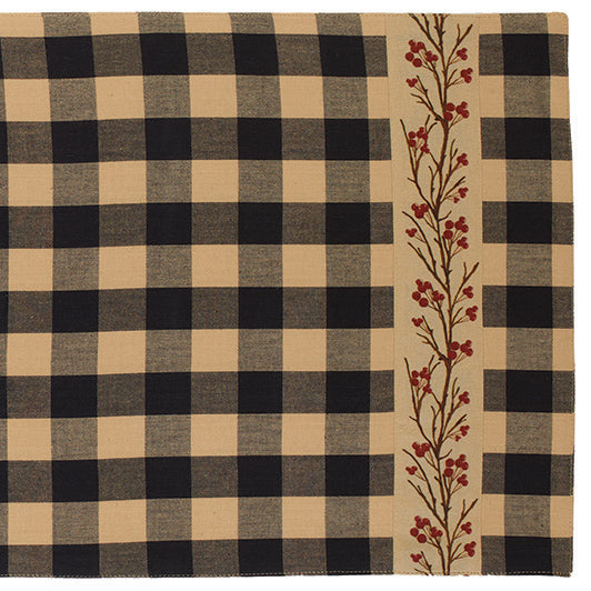 A checkered table runner with a floral border featuring red berries on a beige background.