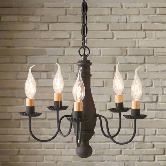 A compact chandelier with a black finish, featuring textured arms and crimped pans, with five E12/Candelabra sockets.
