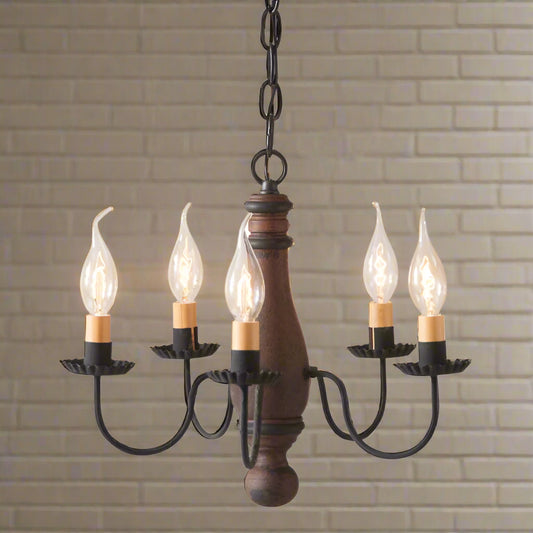 A compact, well-proportioned wooden chandelier with a Hartford Pumpkin with Black Stripes finish, featuring textured black arms with crimped pans and E12/Candelabra sockets.