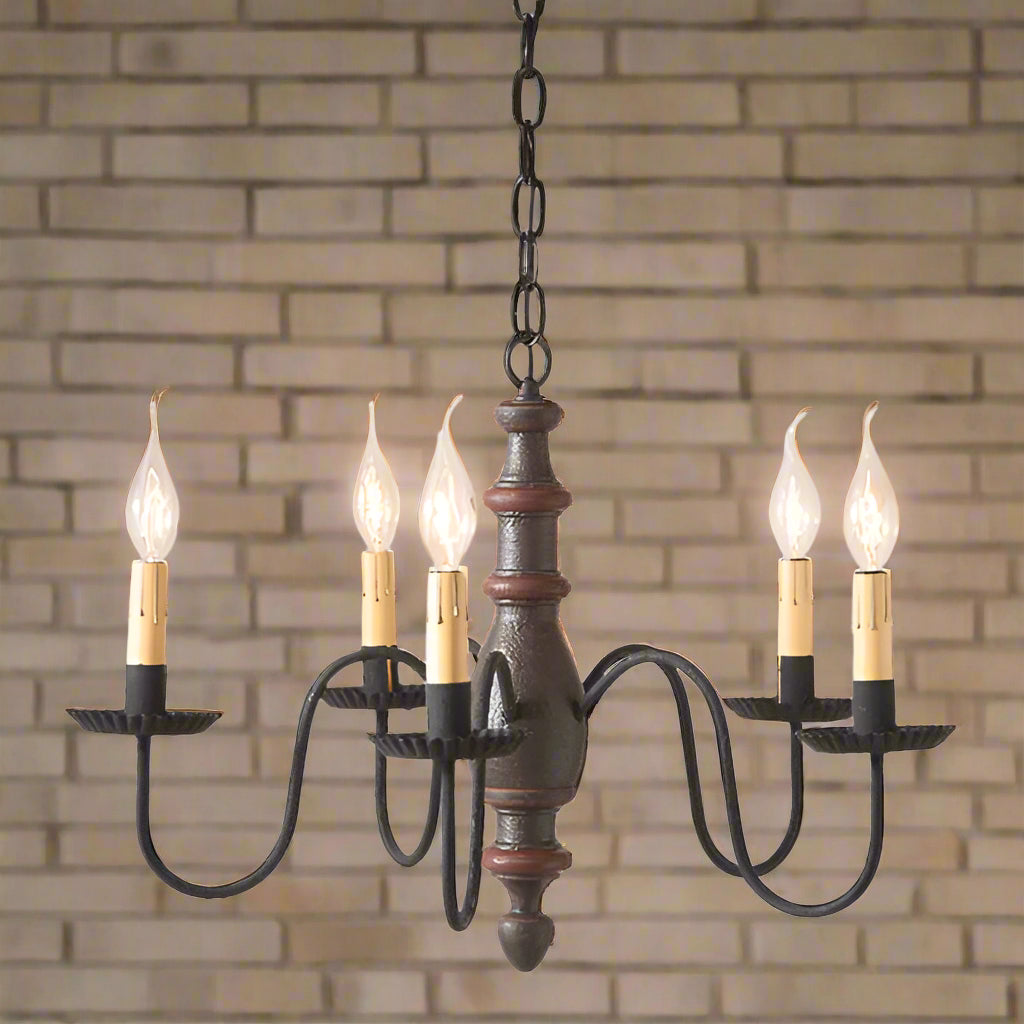 A midsized chandelier with a handspun body and extending arms, featuring a textured espresso finish with black textured arms and crimped pans, with E12/Candelabra sockets.