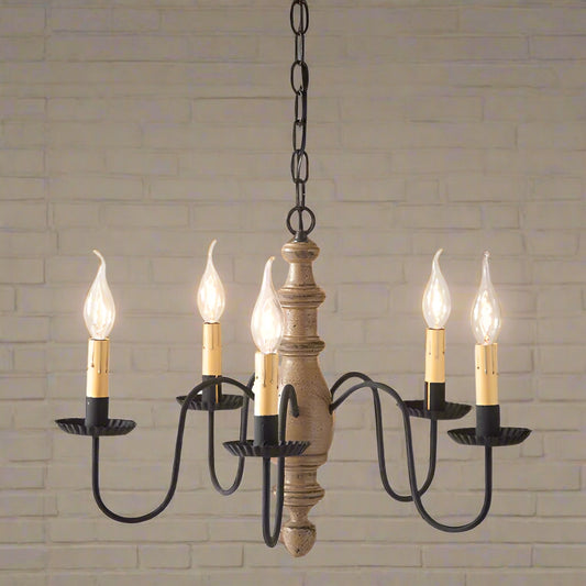 A midsized chandelier with a handspun body in pearwood color, featuring black textured arms and crimped pans, with five E12/Candelabra sockets.
