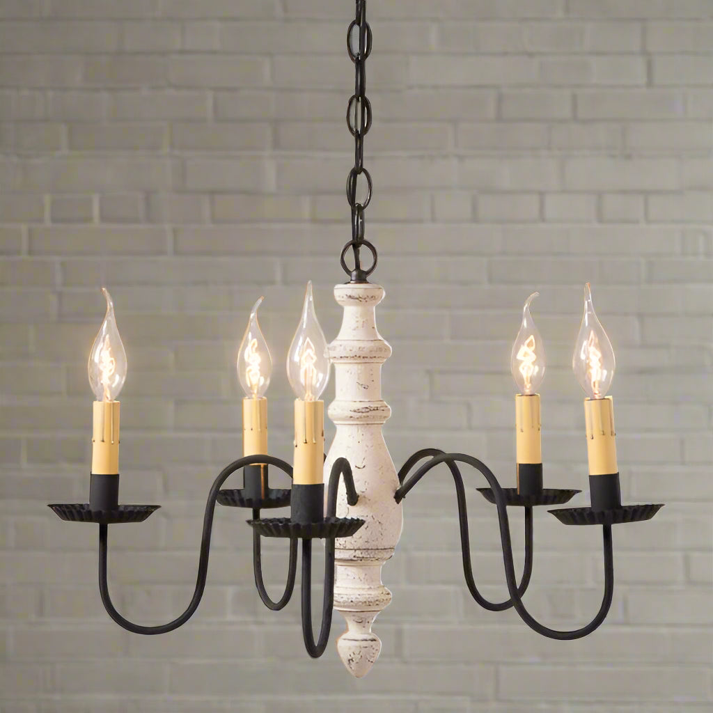 A midsized chandelier with a handspun body in a vintage white finish and black textured arms with E12/Candelabra sockets.