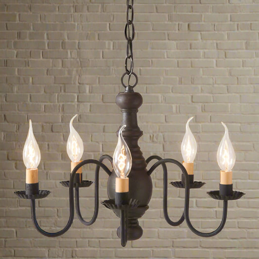 A black, wooden chandelier with five hanging lights and a textured finish, featuring crimped pans and a chain-driven mounting system.