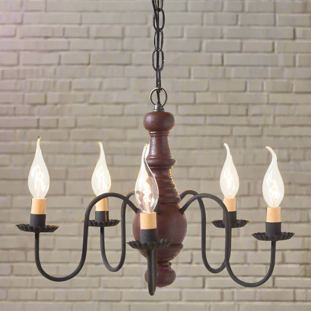 Chandelier with wooden base and black metal arms on a white background