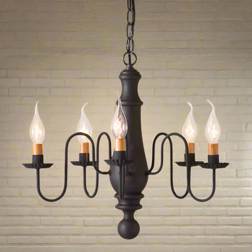A black, wooden chandelier with a rustic finish, featuring textured arms and crimped pans, with five hanging lights.