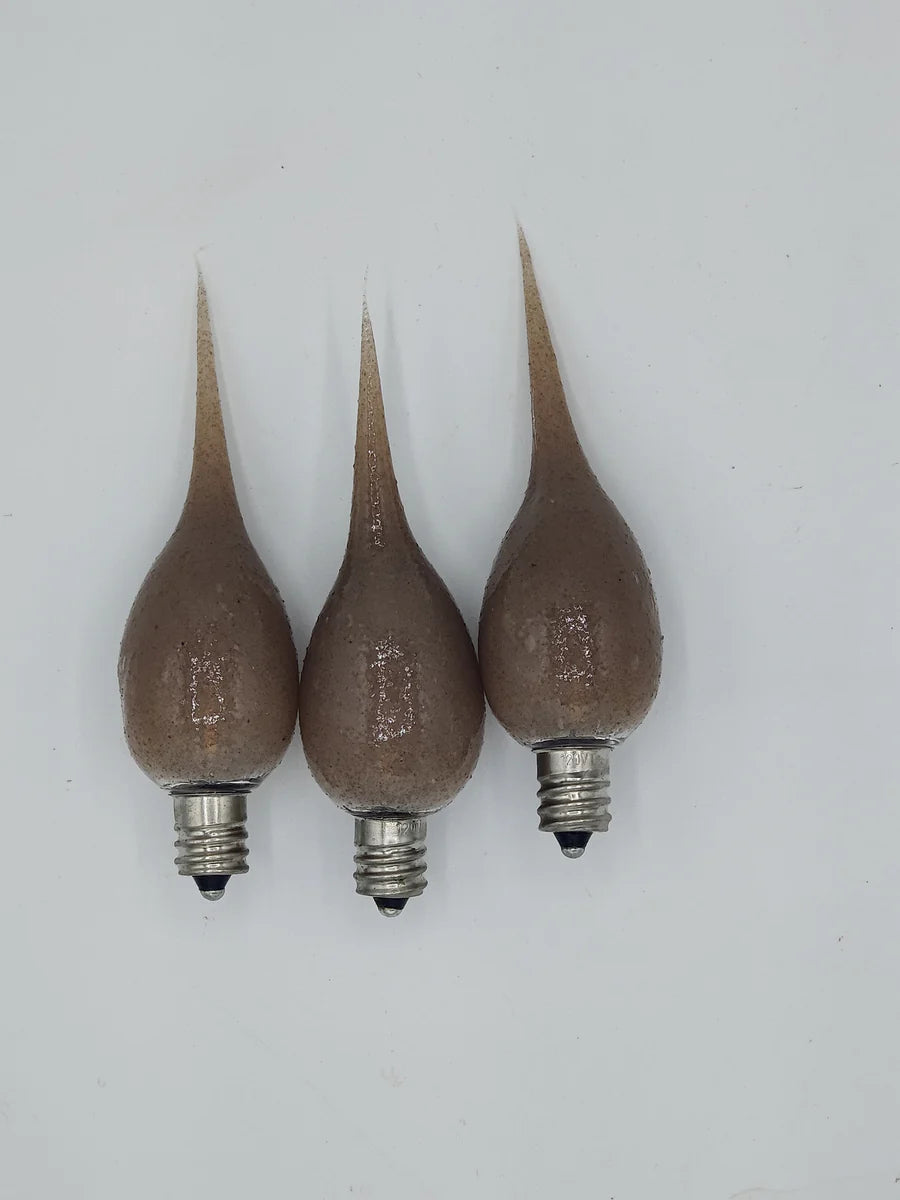 Three brown silicone bulb bases with metal caps, arranged on a white background.