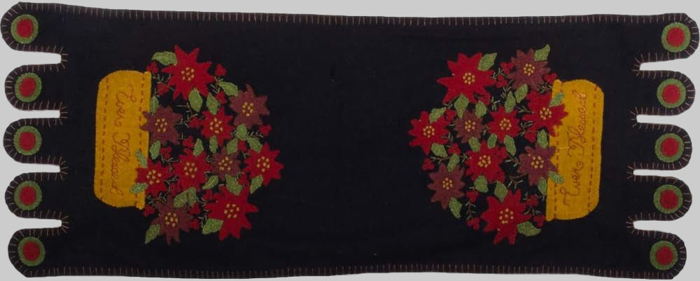 A table runner featuring a floral pattern with red and yellow flowers and green leaves on a black background.