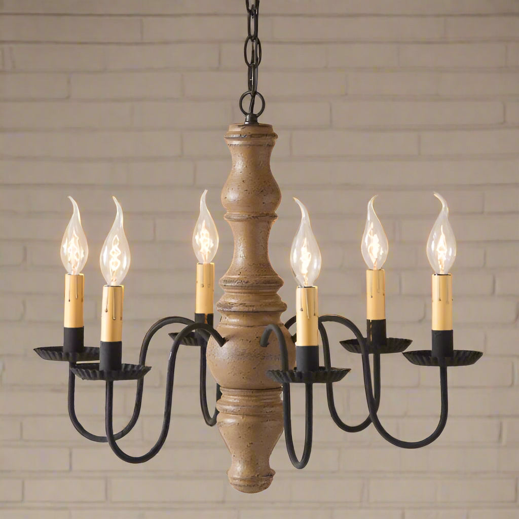 A Gettysburg wooden chandelier with a pearwood finish, black textured arms, and six candle-style lights.
