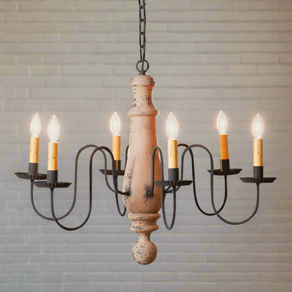 A Large Norfolk wooden chandelier with a Hartford buttermilk finish, featuring a textured, antique look with black arms and a chain of lights.