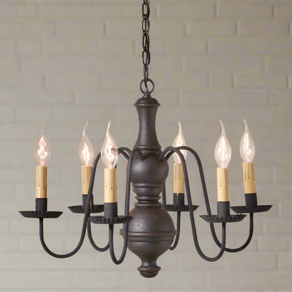 A medium-sized, midsized chesterfield wooden chandelier in an Americana black finish, with textured black arms and multiple candle-like lights.