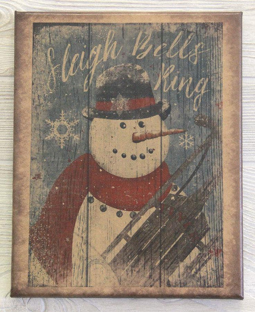 A canvas print featuring a snowman with a red hat and a white beard, holding a sleigh bell rope, with the text 'Sleigh Bells Ring' in a vintage-style font.