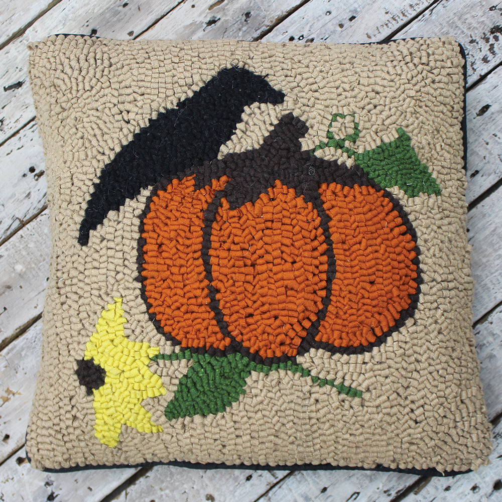 Primitive hooked pillow with crow, orange pumpkin and sunflower