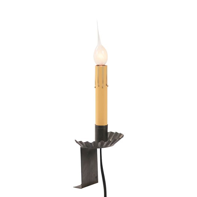 A black window sill light with a candle-like appearance, featuring a lit tip, with a visible power cord.