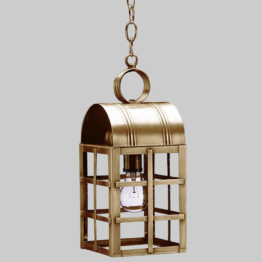 Brass hanging lantern with a clear bulb on a gray background