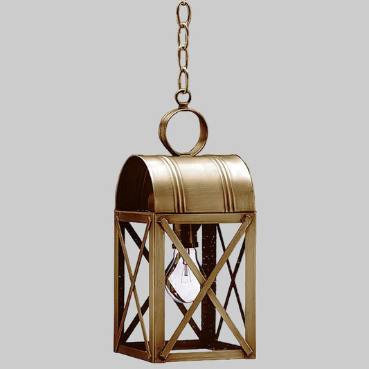 Brass hanging lantern with a visible light bulb on a gray background