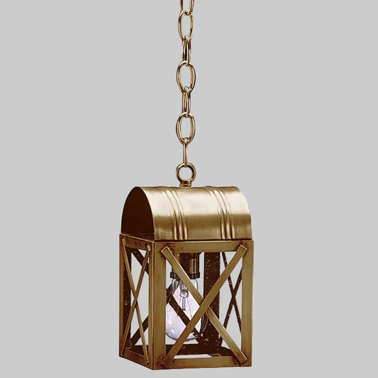 Brass hanging lantern with clear glass on a gray background