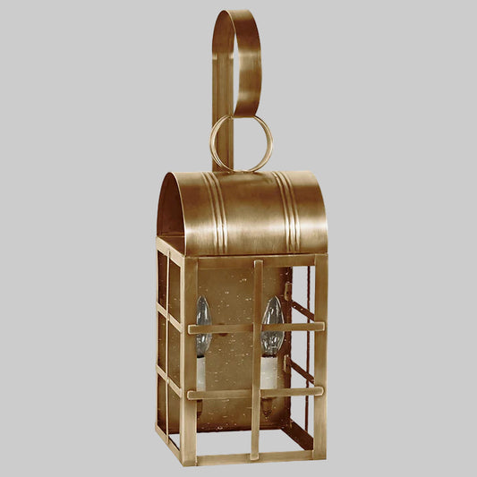 Brass outdoor wall lantern on a gray background