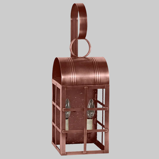 Copper lantern with two glass panels on a gray background