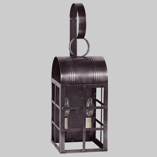 Decorative metal lantern with two glass panels on a gray background