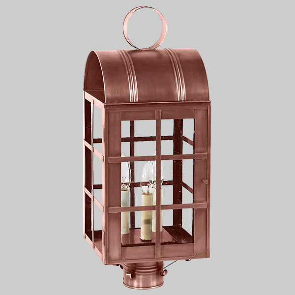Copper lantern with glass panels on a gray background