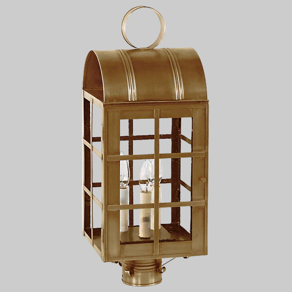 Bronze outdoor lantern with glass panels on a gray background