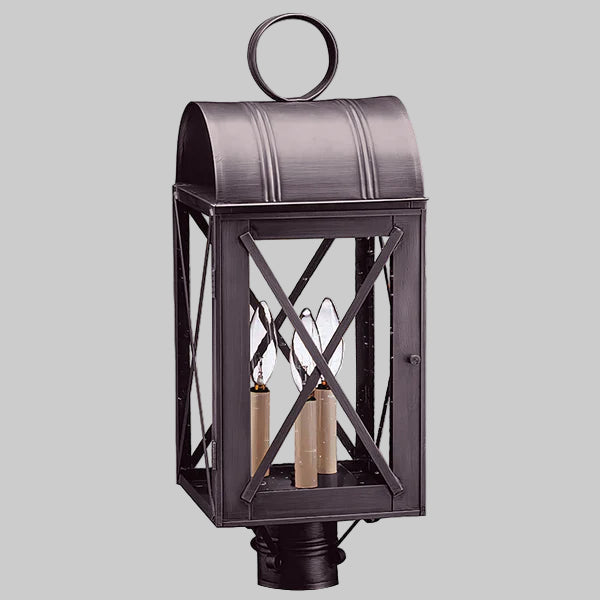 Decorative outdoor lantern with a metallic finish on a gray background