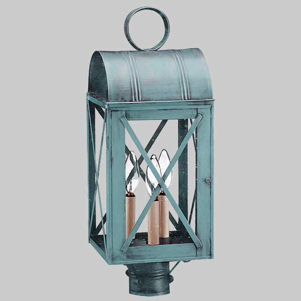 Vintage-style metal lantern with a rustic finish on a gray background