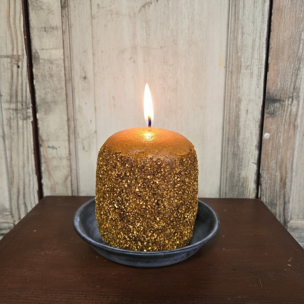 Brown textured candle on a wooden surface