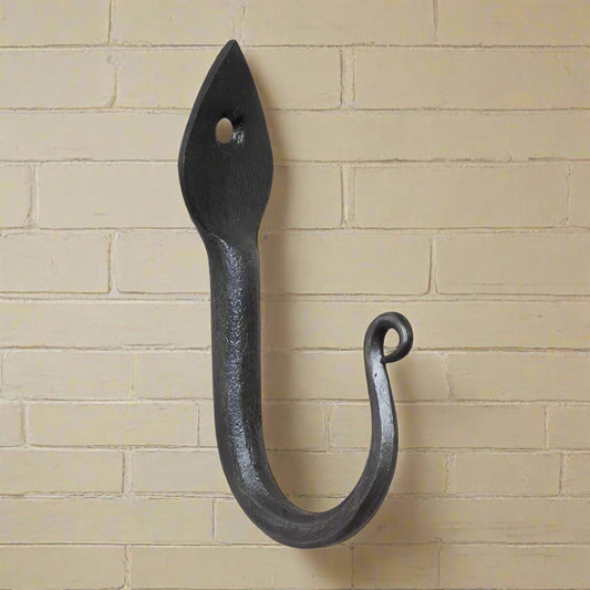 Wrought iron arrow head wall hook on white background