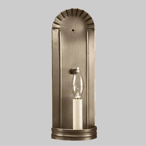 Bronze wall sconce with a clear light bulb on a gray background