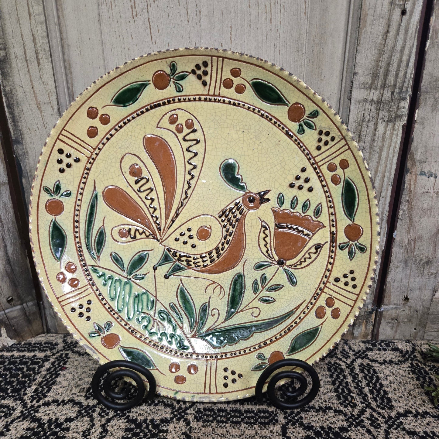 Decorative plate with a bird design on a wooden surface