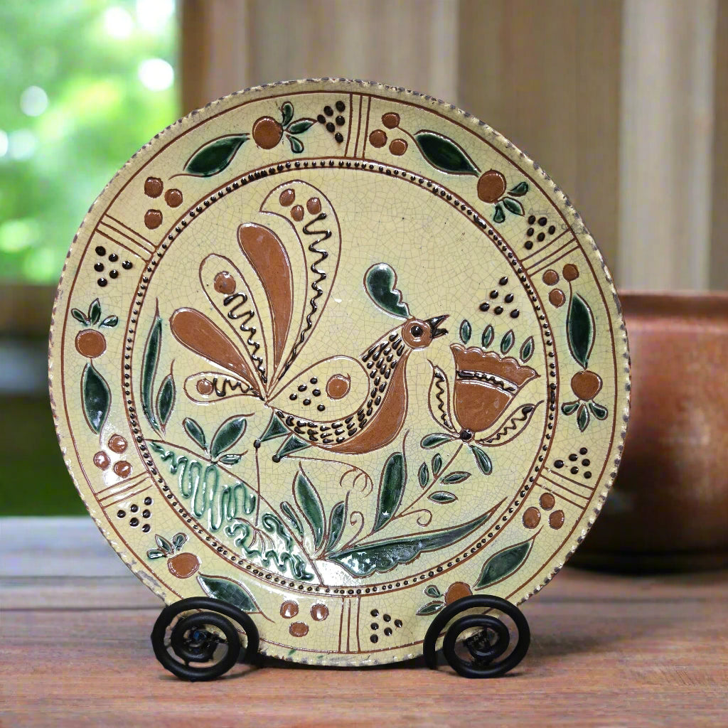 Decorative plate with a bird design on a wooden surface