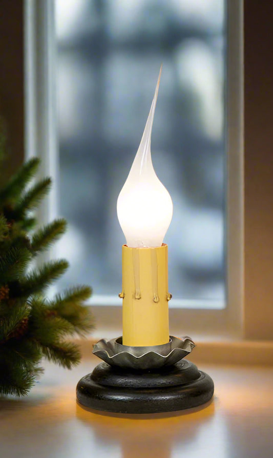 A black window light with a white light bulb, featuring a textured base and a simple design shown in a window.