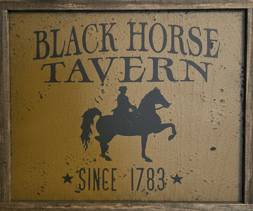 Framed wood sign with horse back rider silhouette.