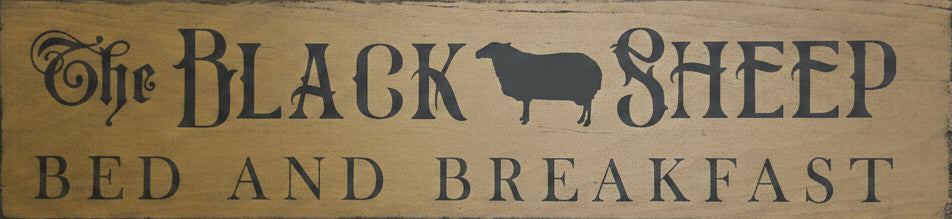 Wooden sign with 'The Black Sheep Bed and Breakfast' on a wooden background