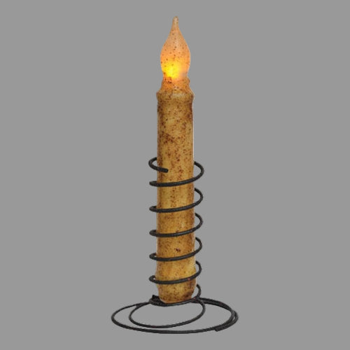 Decorative candle with spiral design and glowing flame on a white background