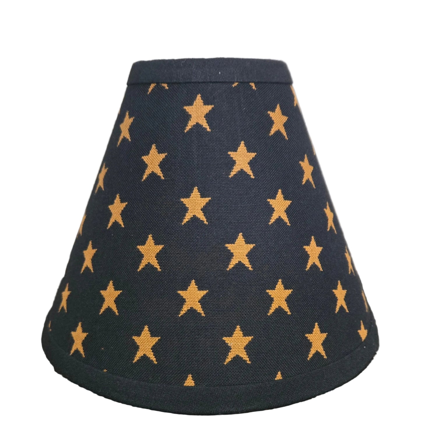 Black lampshade with gold star pattern on a wooden surface