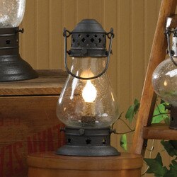 Vintage-style lantern with a lit bulb on a wooden surface