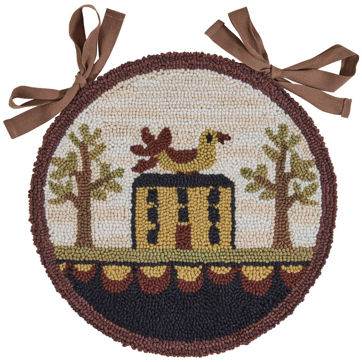 A round chair pad with a 'Bless Our Home' design, featuring an artistic representation of a house, trees, and a chicken, in a hooked rug style.
