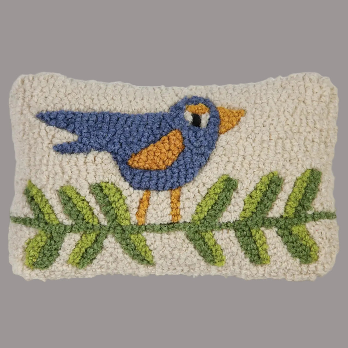 Hooked pillow with a blue bird design on a white background