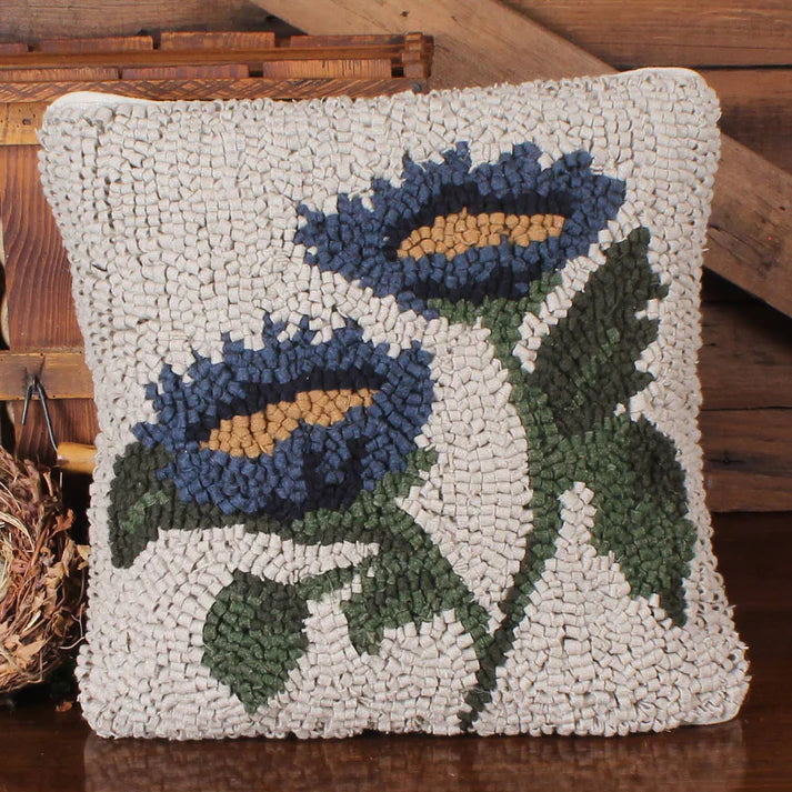 Decorative pillow with floral pattern on a wooden surface