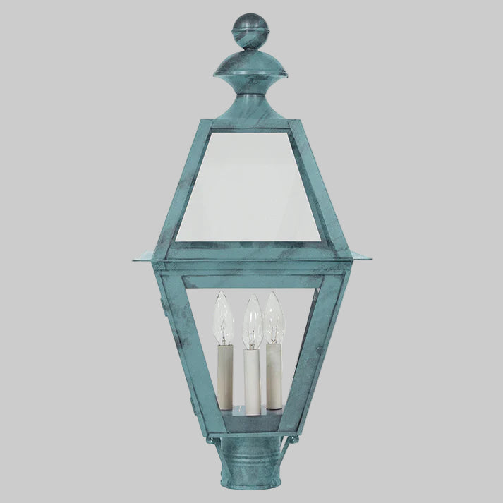 Decorative outdoor lamp with a blue-green finish on a gray background